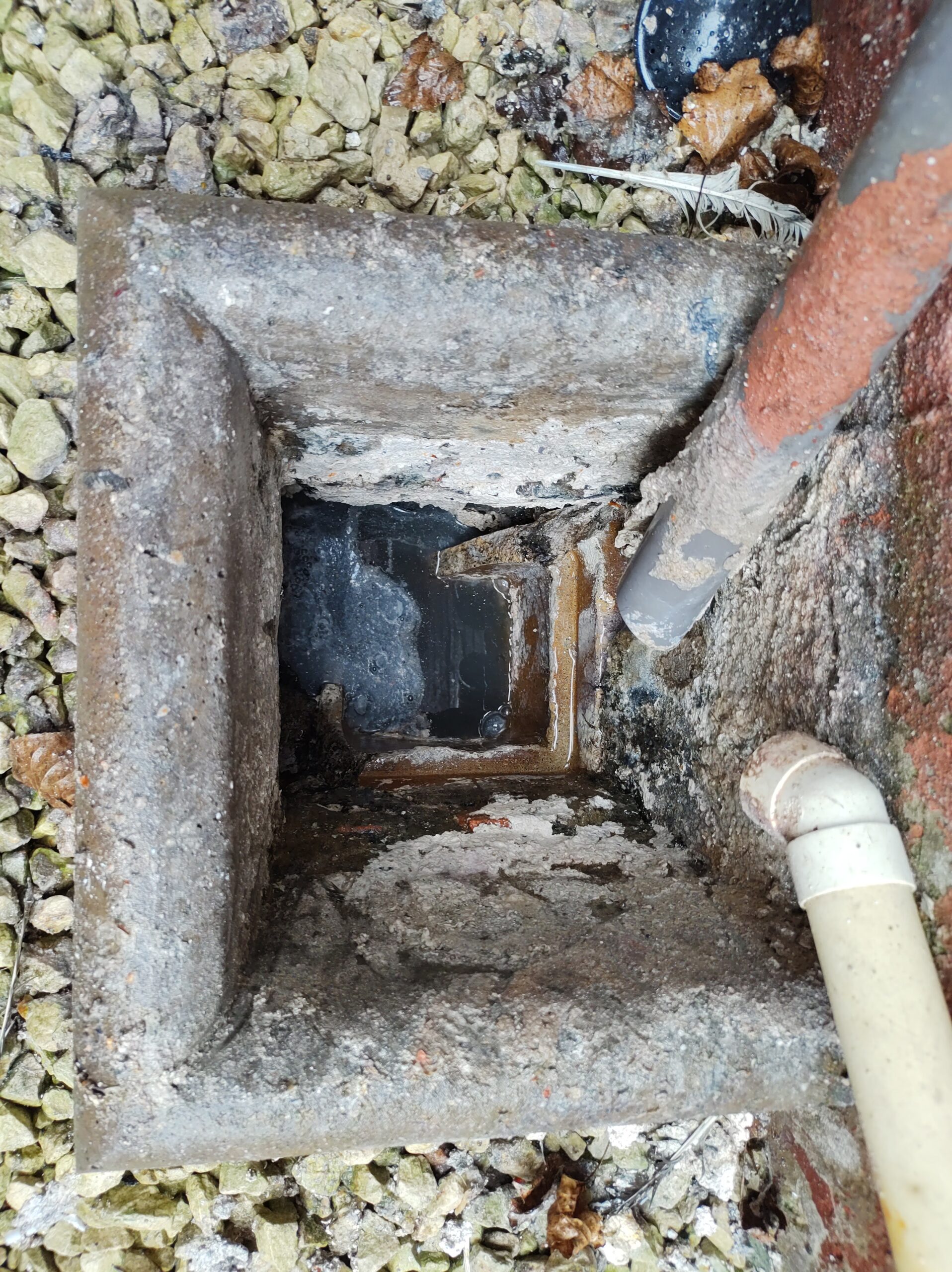 A blocked drain in Thatcham, displaying debris and standing water.