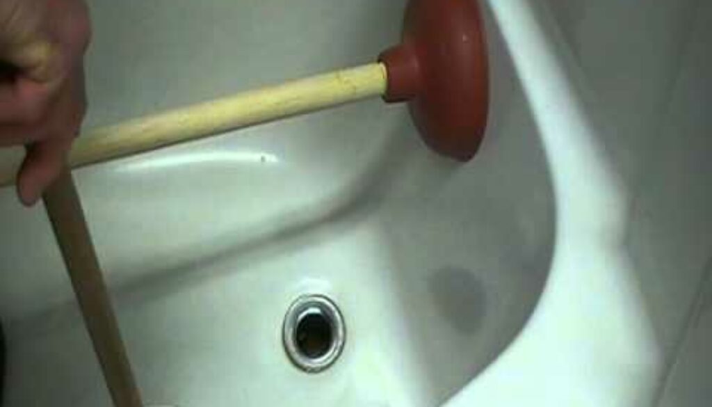 how to unblock a shower drain with a plunger